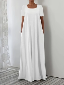 Detail shot of the practical side pockets on a white short-sleeve A-line maxi dress