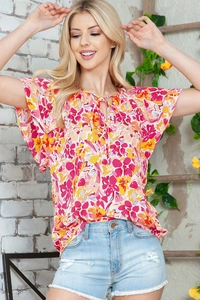 Detail shot of summer floral chiffon blouse with ruffle sleeves and V-neck tie neck design