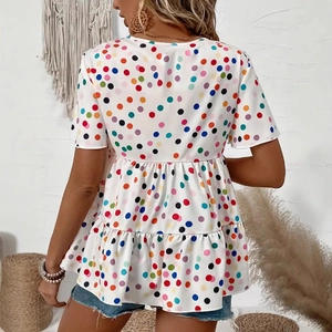 Detail of colorful polka dot print on high-waist tunic with double-layered ruffle hem