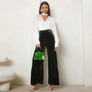 Texture detail of dark green velvet high-waisted wide-leg trousers for women
