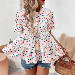 Detail of colorful polka dot print and tiered ruffle hem on a white summer t-shirt