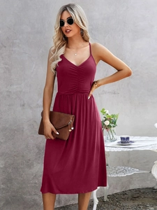 Detail view of the ruched bodice and thin camisole straps on a wine red midi summer dress