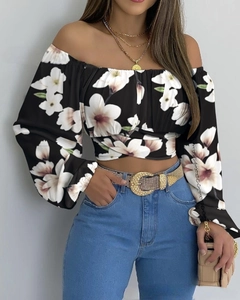 Dettaglio del crop top con spalle scoperte, stampa floreale bianca e nera e maniche a palloncino