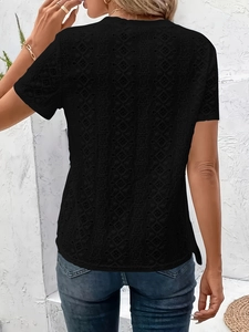 Detail of black hollow lace top showing intricate geometric patterns and slim fit style