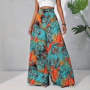 Détail d'un pantalon large à taille haute avec imprimé palmier tropical en turquoise et orange