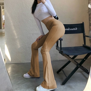 Detail of high waist khaki ribbed flared pants showing elastic knit fabric texture