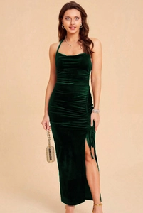 Detailed texture of dark green velvet evening dress with ruched drawstring and side slit