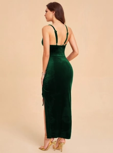 Detail of emerald green velvet evening dress showing side slit and fine fabric texture