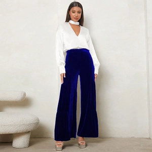 Detail of high-waist royal blue velvet wide-leg trousers paired with white satin top