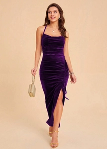 Close-up of ruched side detail and elegant high slit on a purple velvet dress