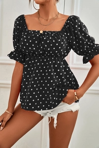 Detail of square neck and polka dot puff sleeves on this elegant black summer blouse