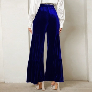 Detail of navy velvet wide-leg trousers with tiered layered design and elastic waist