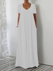 Close-up of white V-neck maxi dress featuring side pockets and loose A-line silhouette