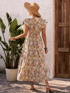 Close-up of light blue floral dress with elastic waist and ruffle sleeves in outdoor setting