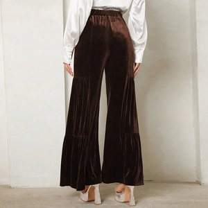 Back view of brown velvet wide-leg trousers with elegant high waist and tiered ruffles
