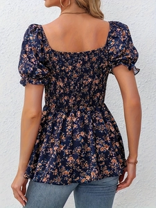 Detail of the elastic smocked back design on this floral puff sleeve blouse for women