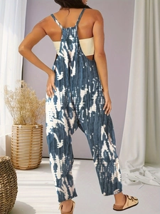 Detailed back view of a breezy blue and white tie-dye jumpsuit with cross-back straps