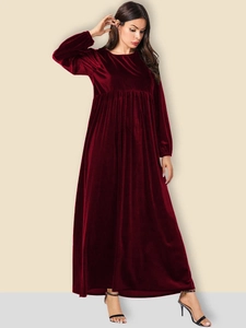 Close-up of elegant burgundy velvet dress showing round neck and high waist pleat details