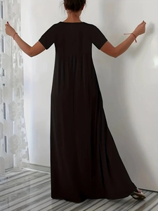 Rear view of long black summer dress showing loose cut and flowing hem detail