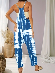 Back view of a plus-size tie-dye jumpsuit with spaghetti straps and an open back design