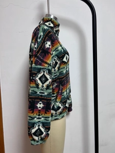 Detailed view of Aztec print fleece jacket with high collar and warm plush texture