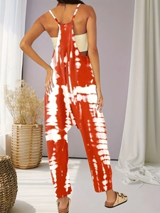 Back view of orange and white tie-dye jumpsuit with thin straps and loose fit style