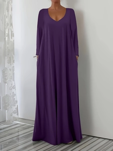 Detail of loose deep purple V-neck maxi dress with long sleeves and hidden side pockets