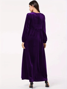 Detail of elegant dark purple velvet dress with smooth texture and long sleeves