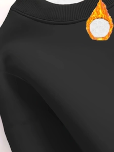 Detail of the crew neck and fleece lining on this minimalist black sweatshirt for women