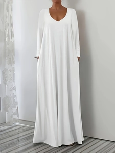 Detailed view of white V-neck long-sleeved dress with elegant A-line flow and soft fabric