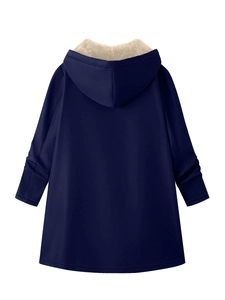 Detail view of the plush cream fleece lining and dark blue fabric of the hooded parka