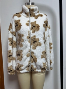 Detail of soft fleece jacket featuring a stand-up collar and brown bear print patterns