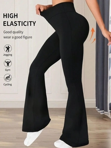 Detail showing high elasticity fabric and body-shaping fit of black flare yoga pants