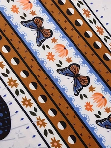 Detailed pattern showing bohemian floral print with butterflies and moon phase elements