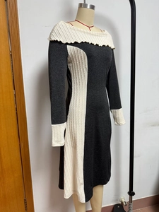 Detail of elegant two-tone knit dress with wide fold-over collar and striped paneling