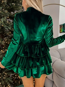 Detail of emerald green velvet tiered dress with high waist and back view on model