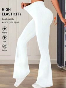 Close-up of white high-waisted flared yoga pants with elastic waist and slimming fit