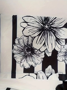 Close-up of black and white floral print fabric with vertical stripes on casual wide-leg pants