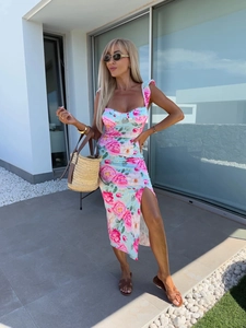 Detailed view of light blue floral dress with side slit and pink rose print pattern