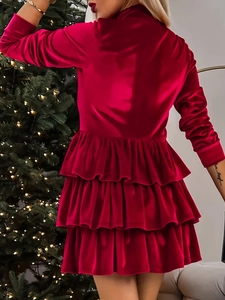 Detailed view of red velvet tiered ruffle hem dress in a festive Christmas setting