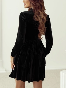 Elegant black velvet high-neck mini tiered dress for women in a side-rear model view
