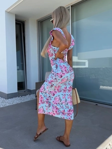 Detail of light blue floral dress showing ruffled shoulder straps and side split hemline