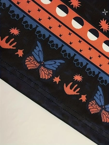 Detailed close-up of mystic pattern print and high-quality double-needle stitching