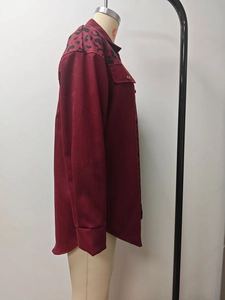 Detail view of burgundy cardigan jacket with leopard print patches and button closure