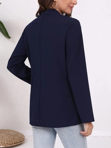 Slim-fit dark blue blazer for women in casual business style shown from a back side view