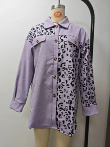 Detail view of purple shirt featuring asymmetrical leopard print and wooden buttons