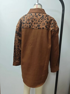 Detail view of the brown shirt back with leopard print panels on shoulders and sleeves