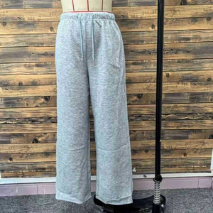 Detail view of the elastic drawstring waistband on these gray wide-leg sweatpants