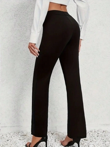Back view of high waisted black straight leg trousers styled for a minimal office look