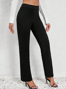 Detail of high-waist black wide-leg trousers with sleek draping and minimalist design